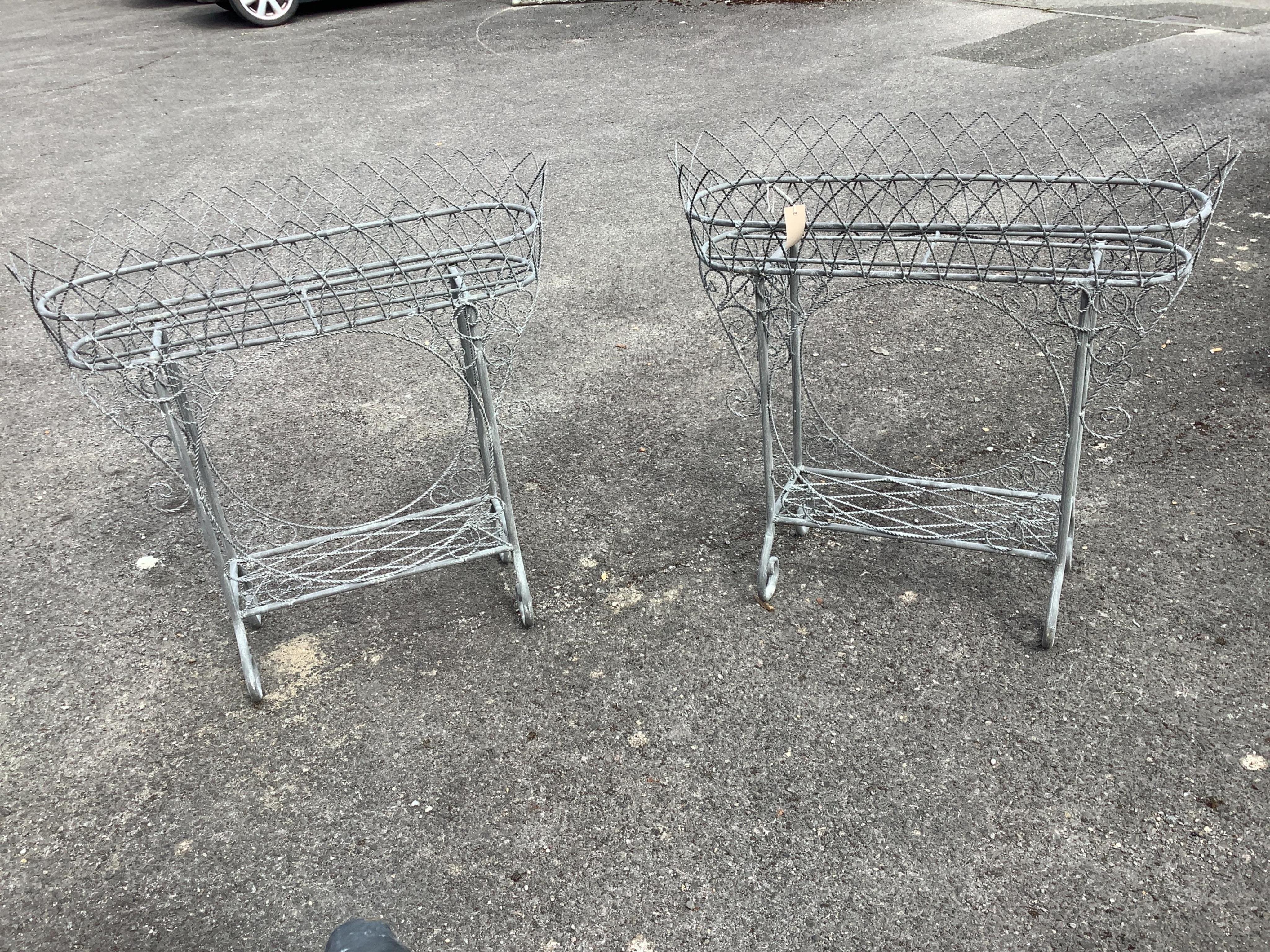 A pair of Victorian style wirework two tier pot stands, width 87cm, height 87cm. Condition - good